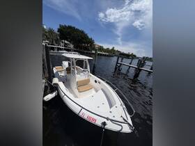A sleek speedboat docked at a waterfront, showcasing its modern design and spacious seating — perfect for a day on the water.