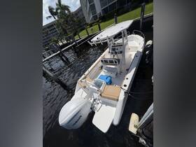 A sleek center console boat docked at the marina, showcasing its modern design and features, perfect for fishing or leisure outings.