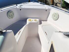 Interior view of a boat's helm area featuring seating and speakers, ideal for enjoying time on the water.