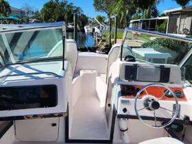 Interior view of a boat's helm and console area, showcasing the steering wheel and controls, perfect for navigating the waterways.