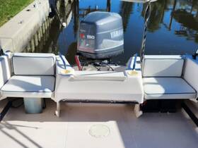 Interior view of a boat's seating area featuring comfortable cushions and a Yamaha outboard motor, perfect for relaxing on the water.