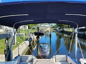 A view from the helm of a boat, showcasing the shaded interior and the serene canal setting outside, perfect for relaxing before setting out on the water.