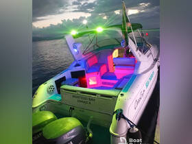 A vibrant interior view of the 'Sea Therapy' boat in Montego Bay, Jamaica, showcasing colorful seating and ambient lighting, perfect for evening cruises.