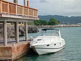 A sleek speedboat docked at a waterfront, surrounded by scenic views of the coastline and mountains, perfect for a day out on the water.
