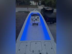 An interior view of a boat's helm featuring illuminated seating, showcasing a modern design perfect for comfortable navigation.