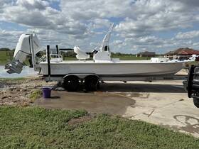 A pristine Haynie boat docked and ready for adventure, showcasing its sleek design and powerful motor against a scenic backdrop.