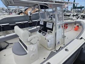 Interior view of a boat's helm and seating area, showcasing the modern console and comfortable seating, ideal for navigation and relaxation on the water.