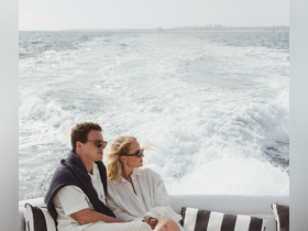 A couple enjoys a scenic boat ride, capturing a moment of relaxation and romance on the open water.