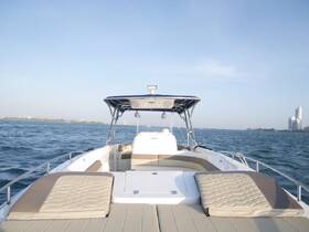A clean and spacious interior view of a boat's helm and seating area, showcasing comfortable lounging space ideal for relaxing on the water.