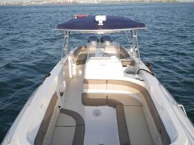Interior view of a well-appointed boat helm and seating area, showcasing comfortable lounge space ideal for relaxing on the water.