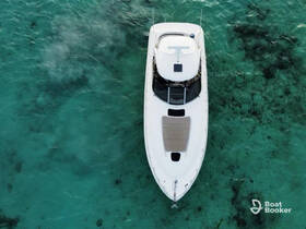 Aerial view of a sleek boat cruising over crystal-clear waters, showcasing the beauty of the marine environment.