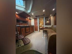 Interior view of a luxurious boat cabin featuring a well-equipped kitchen area and comfortable seating, perfect for relaxing during your nautical adventures.