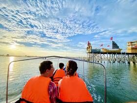 A group of friends enjoys a scenic boat ride at sunset, with a picturesque pier in the background — a perfect moment for adventure and exploration on the water.