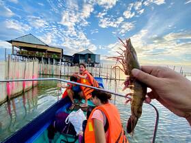 A joyful group of friends on a boat, showcasing their catch of shrimp while enjoying a fun day on the water — perfect for seafood lovers and adventure seekers.