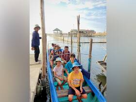 A cheerful family enjoys a boat tour, ready for an adventure on the water. Perfect for creating lasting memories together.