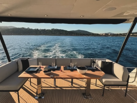 A beautifully arranged dining area inside a yacht, featuring elegant seating and table settings, perfect for enjoying meals while cruising on the water.