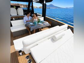 A couple enjoys a romantic dining experience on the spacious interior of a luxury yacht, complete with elegant table settings and stunning waterfront views.