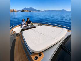 A couple enjoys a toast with champagne on the deck of a luxurious yacht, with stunning views of Mount Vesuvius in the background — an ideal setting for romantic getaways or special celebrations.