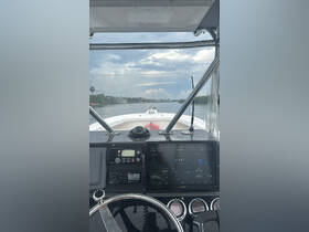 View from the helm of a boat, showcasing the control console and navigation equipment, perfect for boating enthusiasts and captains.