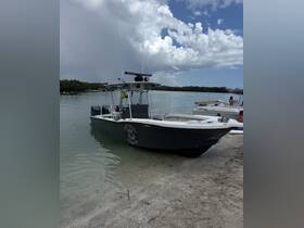 A sleek speedboat is docked on a sandy shore, surrounded by calm waters and lush greenery, perfect for a day of adventure on the water.
