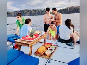 A lively family gathering on a boat, enjoying delicious snacks and quality time together — perfect for memorable outings on the water.