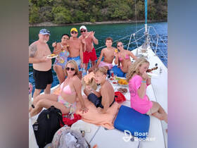 A lively group enjoys a fun day on the water, sharing food and drinks aboard a boat — perfect for celebrations and family outings.