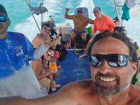 A lively group enjoys a fun day on the water, sharing drinks and smiles aboard a boat — perfect for memorable adventures and celebrations.