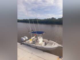 A sleek speedboat named 'Tillo' docked by the river, showcasing its fishing gear and spacious seating — perfect for a day on the water.