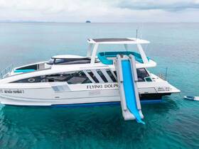A stunning aerial view of the 'Flying Dolphin' yacht, showcasing its sleek design and water slide, perfect for fun-filled days on the water.