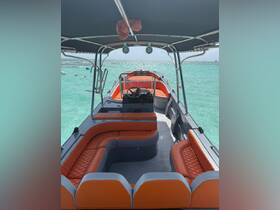 Interior view of a stylish boat featuring comfortable seating and a helm, perfect for enjoying a day on the water.