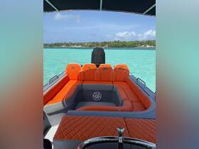A stylish interior view of a boat featuring vibrant orange seating, perfect for relaxing on the water. Ideal for day trips or leisurely cruises.