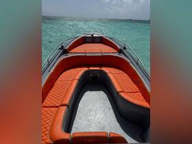Interior view of a stylish boat featuring vibrant orange seating, perfect for comfortable cruising on the water.