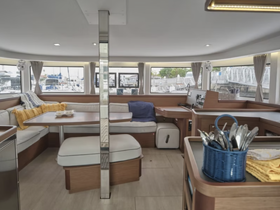 Interior view of a spacious boat cabin featuring comfortable seating and a well-equipped helm area, perfect for relaxing or navigating during your maritime adventures.