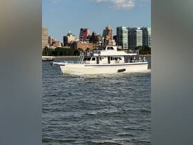 A sleek yacht navigates the waters with a vibrant city skyline in the background, showcasing a perfect blend of urban and nautical scenery.