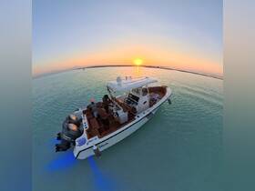 A couple enjoys a stunning sunset aboard a boat, creating a perfect backdrop for romantic moments on the water.