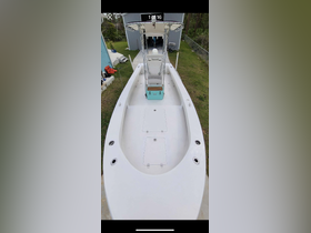 An interior view of a well-equipped boat helm featuring seating and storage, ideal for fishing or cruising adventures.
