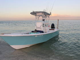 A beautiful fishing boat anchored in shallow waters, showcasing its sleek design and fishing gear, perfect for a day on the water.