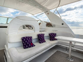 A stylish interior view of a boat's seating area, featuring comfortable cushions and a sleek design, perfect for relaxing while cruising on the water.