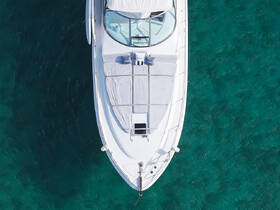 Aerial view of a sleek yacht showcasing its elegant design and spacious sunbathing area, perfect for luxurious outings on the water.