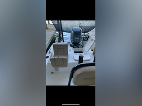 Interior view of a well-equipped boat helm featuring comfortable seating and a console, ideal for fishing or leisure outings.