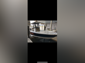 A sleek center console boat docked in a marina, showcasing its clean lines and spacious layout, perfect for fishing or day trips.