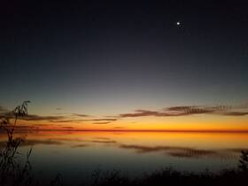 A breathtaking sunset over calm waters, showcasing vibrant colors and serene reflections — a perfect backdrop for evening boat trips or peaceful moments by the shore.