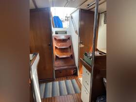 Interior view of a boat cabin showcasing the staircase and wooden finishes, ideal for relaxing or navigating below deck.