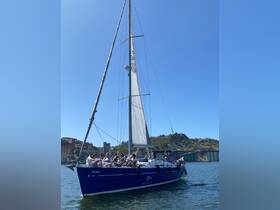 A lively group enjoys a sailing adventure aboard the 'Primus,' surrounded by stunning scenery and clear waters — perfect for memorable outings on the water.