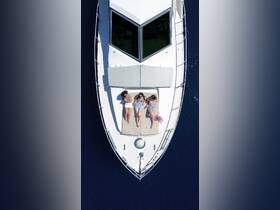 Three friends relax and sunbathe on the deck of a boat, enjoying a perfect day on the water together.