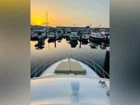 A stunning view from the front of a yacht at sunset, showcasing the serene marina filled with boats — perfect for a relaxing evening on the water.