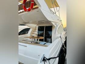 A glimpse into the elegant interior of a yacht, showcasing comfortable seating and a dining area, perfect for relaxing while enjoying the water.