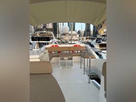 A spacious interior view of a yacht's lounge area, featuring comfortable seating and a stylish design, perfect for relaxing while enjoying the marina skyline.
