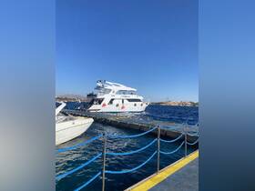 A stunning view of a yacht docked at the marina, showcasing its elegant design against a clear blue sky — perfect for luxury charters and day trips.