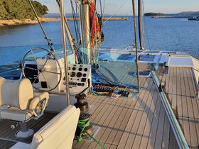 A well-equipped helm area of a yacht, showcasing the steering wheel and control console, perfect for navigating the open waters.